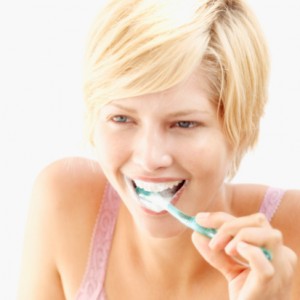 close-up of a young woman brushing her teeth